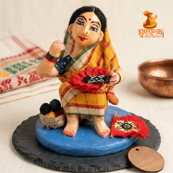 সেলাই রত পল্লীবধূ